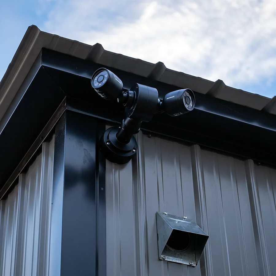 Dual bullet security cameras mounted on a commercial metal building