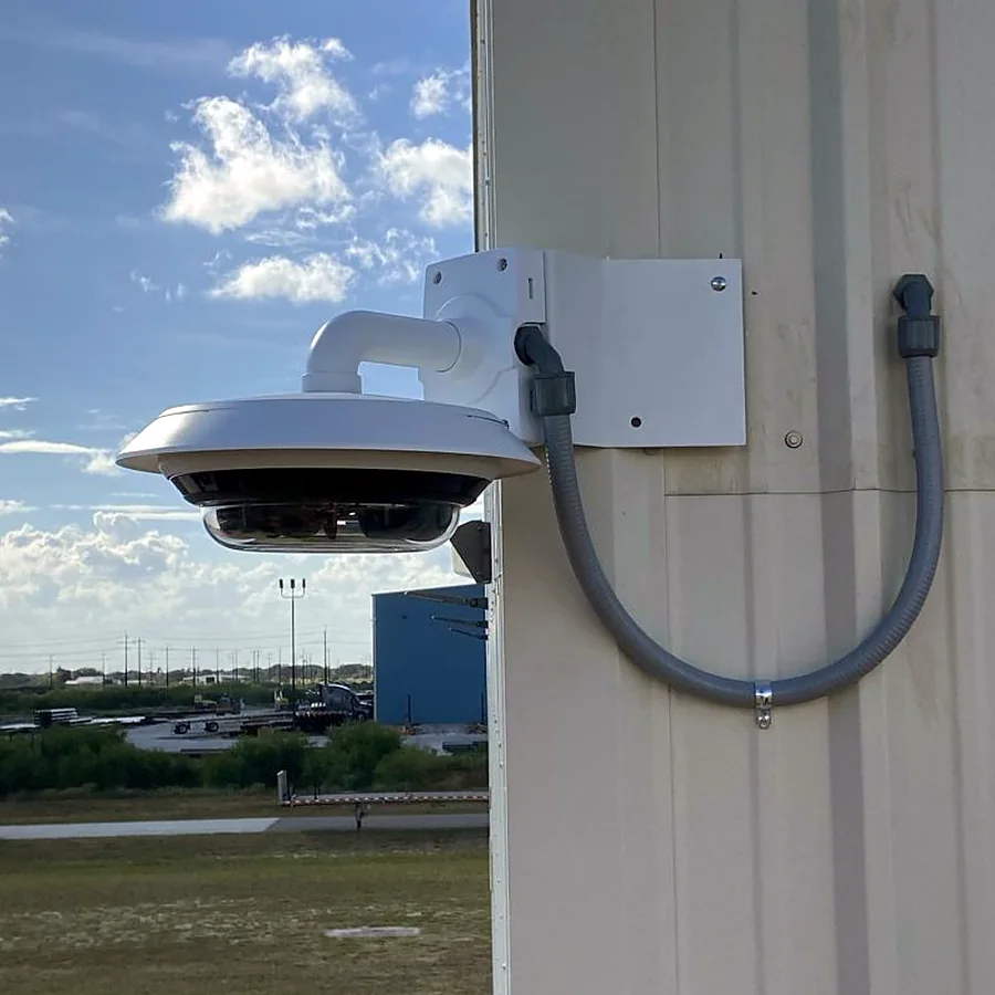 Multi-sensor panoramic security camera on a wall bracket with conduit